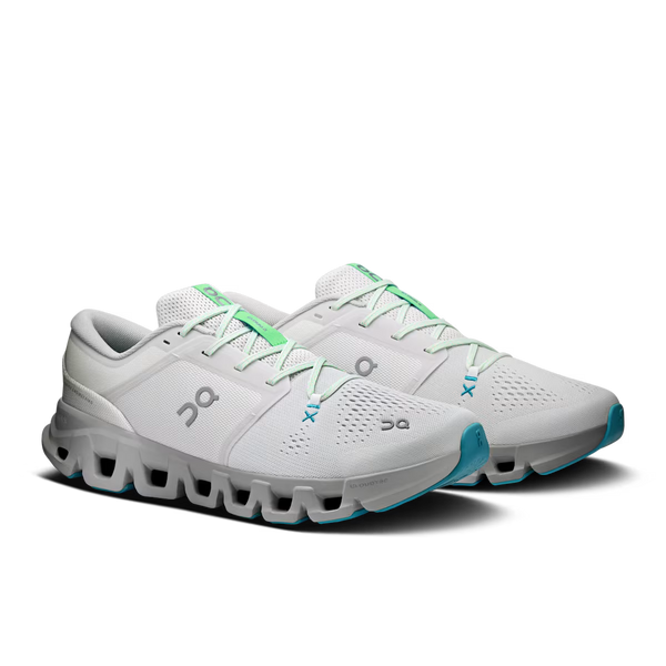 A pair of On running shoes in white and light gray with mint green accents and turquoise outsole details, shown on a clean white background.