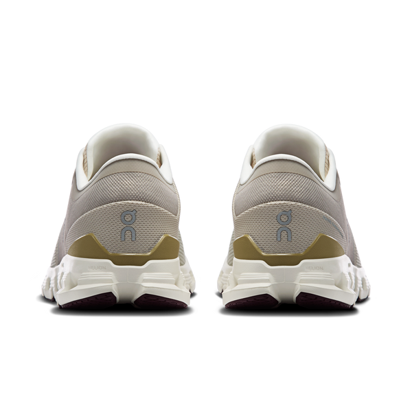 Pair of gray running shoes with white soles on a white background