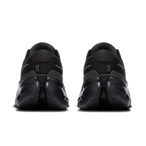 Black athletic shoes with 'OC' branding on a white background