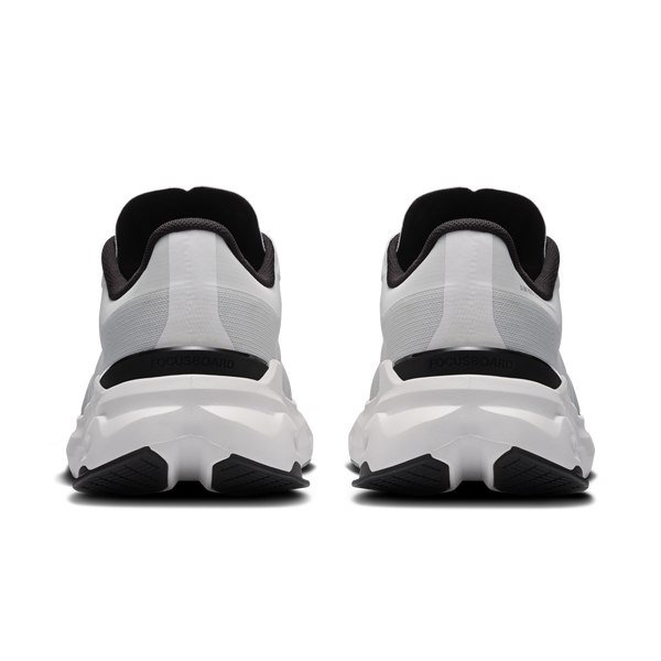 White and black athletic shoes shown from the back on a white background