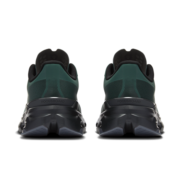 Green and black athletic shoes with branding on a white background