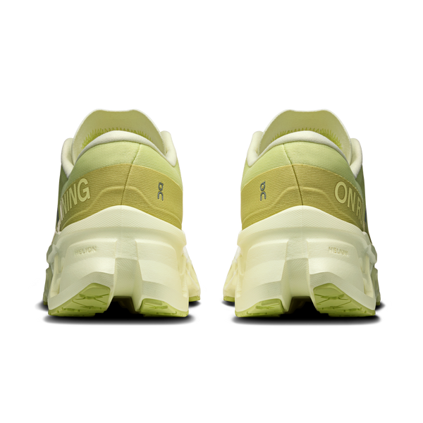 Pair of green running shoes with white soles on a white background