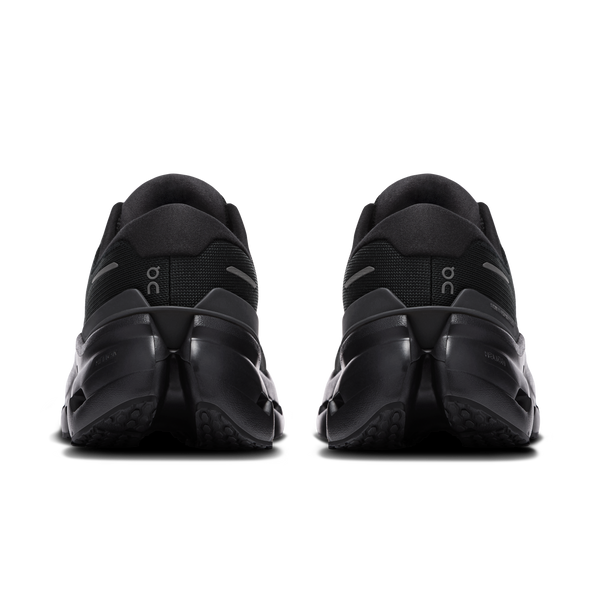 Black athletic shoes with 'OC' branding on a white background