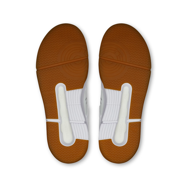 Top-down view of a pair of athletic shoe soles, showing a brown textured outsole with white midsoles and heel inserts, isolated on a white background.