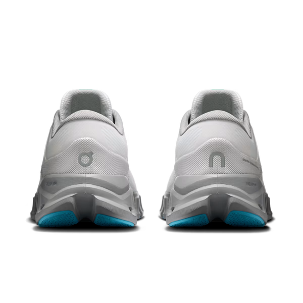 A pair of light gray running shoes shown from the back, featuring a chunky gray and white sole with bright blue outsole accents.