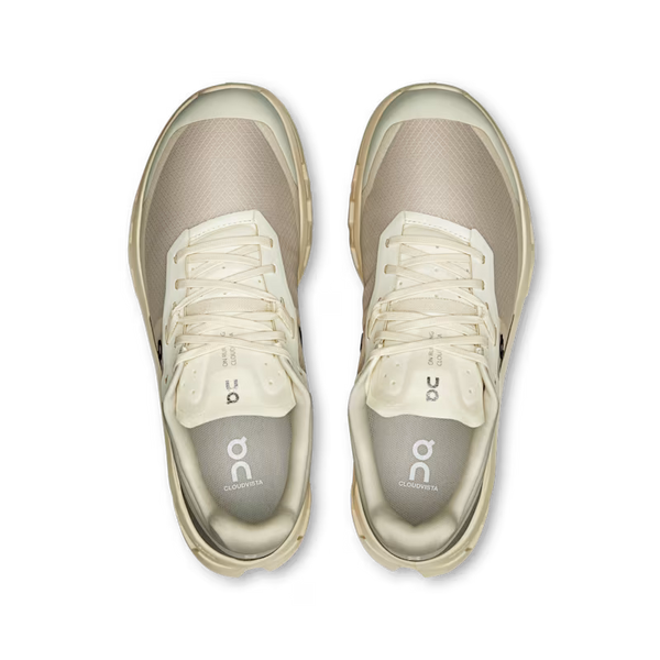 Pair of beige athletic shoes on a white background