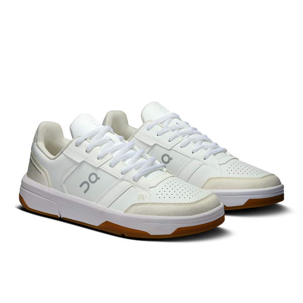 White sneakers with brown soles on a white background
