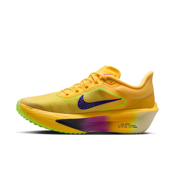 Yellow running shoe with a colorful sole on a white background