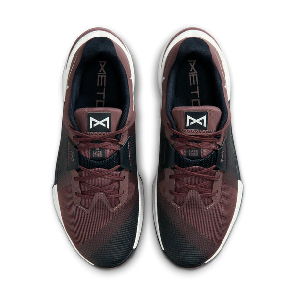Pair of maroon and black athletic shoes with white soles on a white background