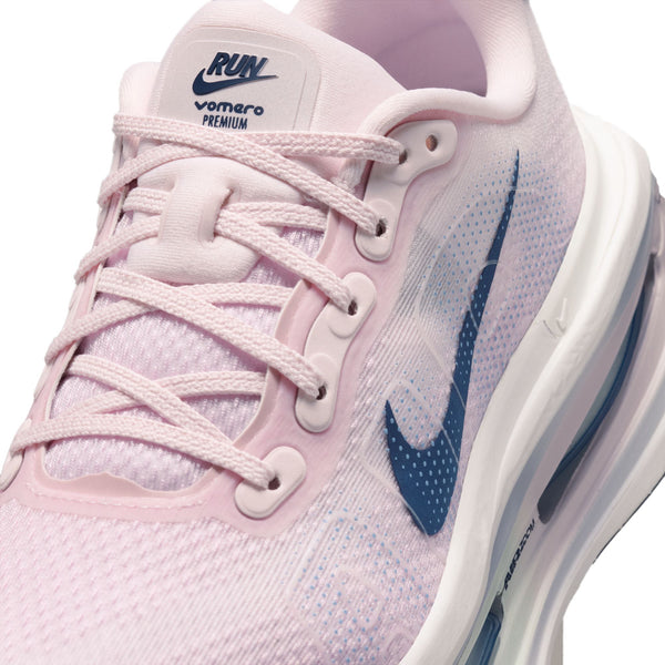 CLose up of the upper of a Vomero Premium witht a pink upper and violet Nike swoosh.