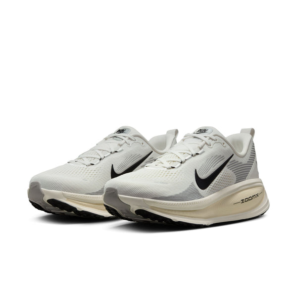 Pair of white running shoes with Nike logo on a white background