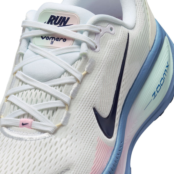 A close up on the lateral side and instep of a Nike Vomero 18 with a white upper.