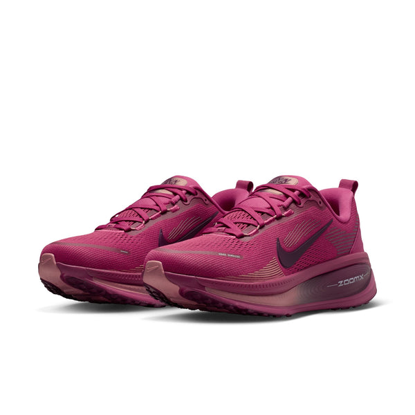 A pair of pink running shoes with Nike logo on a white background.