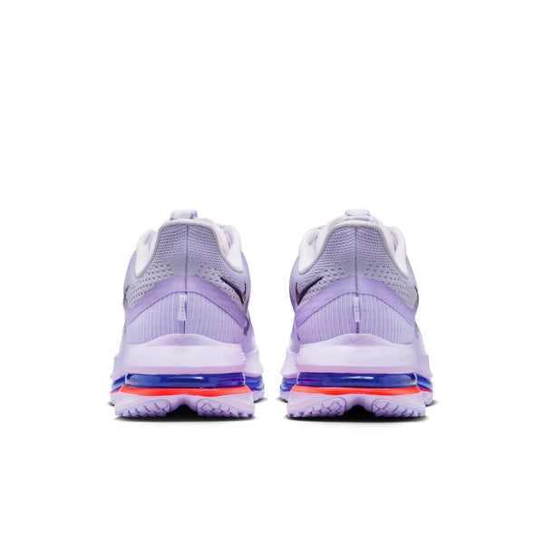 Pair of purple running shoes with white soles on a white background