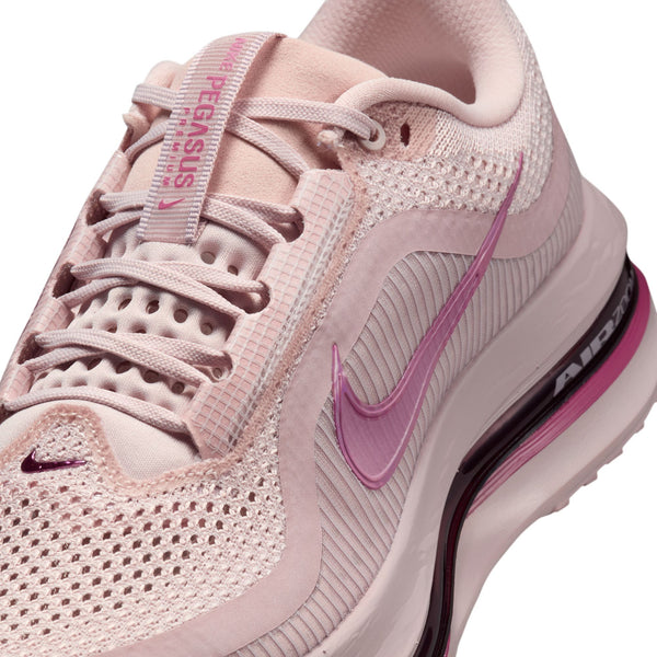 Pink Nike running shoe with visible brand logo on a white background.
