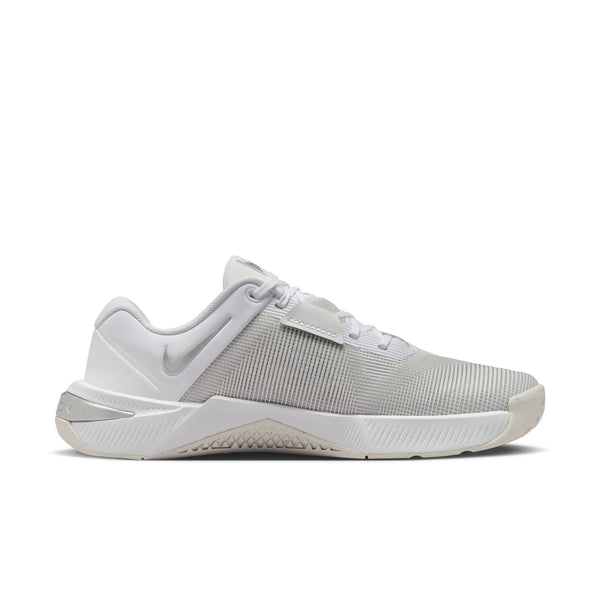 White Nike gym/athletic shoe on a white background.