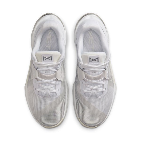 Pair of white athletic shoes with brand logo on a white background.