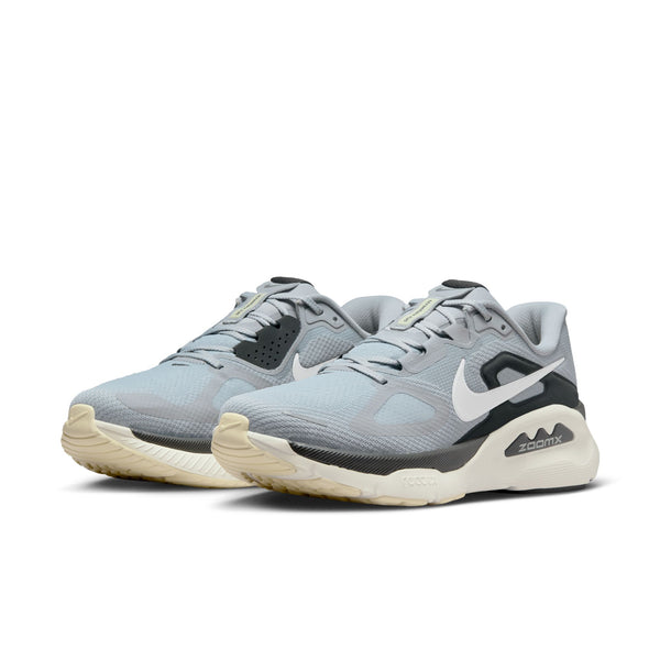 Pair of gray athletic shoes with a Nike logo on a white background