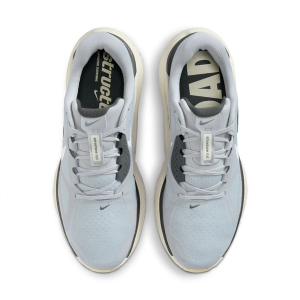 Pair of light gray sneakers with visible branding on a white background