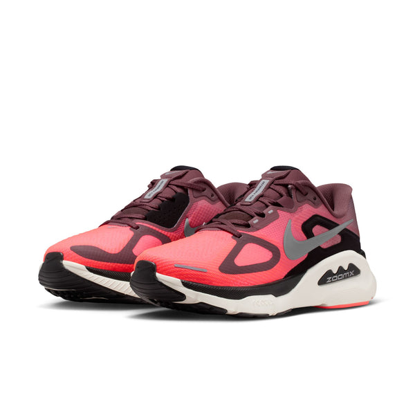 Pink and black athletic shoes with a visible brand logo on a white background