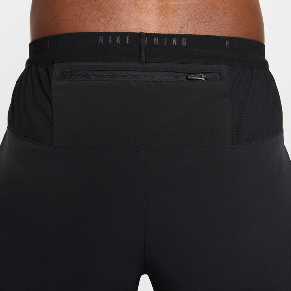 Black Nike pants with a focus on the waistband and pocket area.