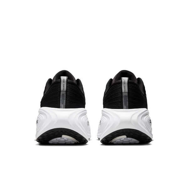 The heel area of a Nike Vomero Plus black and white athletic shoes on a white background.