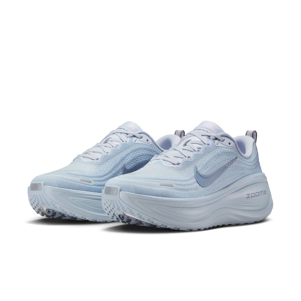A pair of Nike light blue running shoes with white soles on a white background.