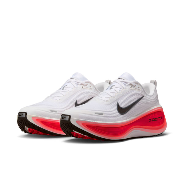 White running shoes with red sole on a white background.