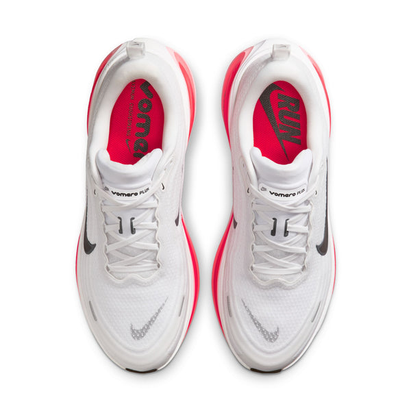 A pair of white running shoes with red soles on a white background.