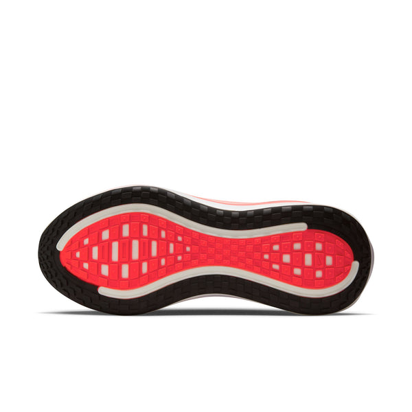 Close-up of a shoe sole with red and black design on a white background.
