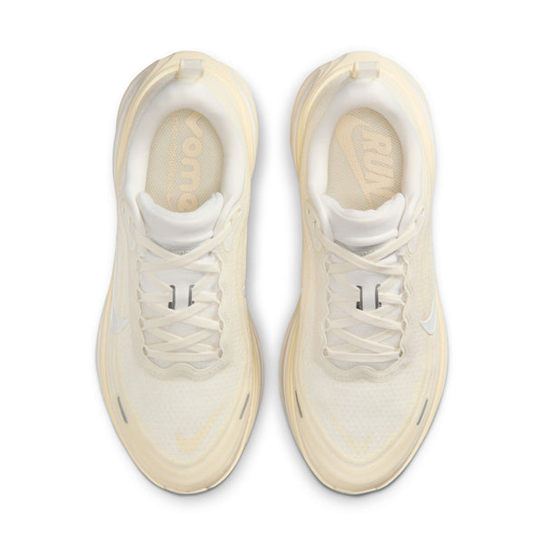 Pair of cream-colored sneakers with white laces on a white background