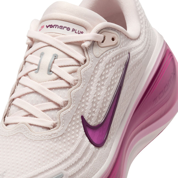 Pink and white sneaker with Nike logo on a white background