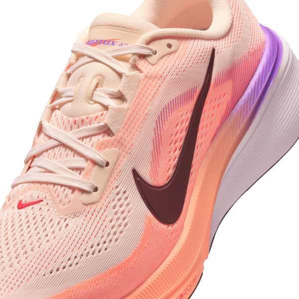 Pink running shoe with Nike logo on a white background