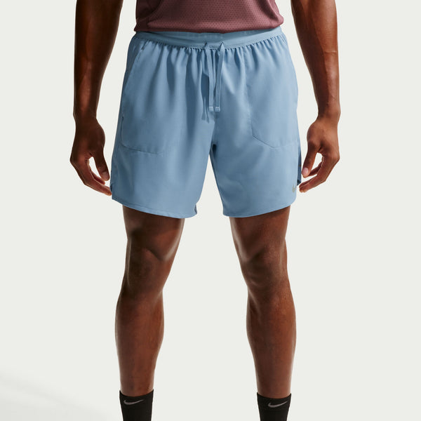 Person wearing light blue athletic shorts on a plain background