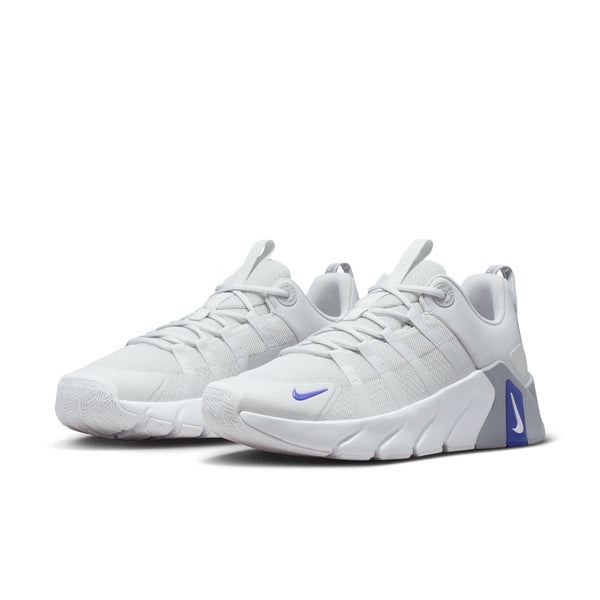 Pair of light pink running shoes with a subtle pattern on a white background