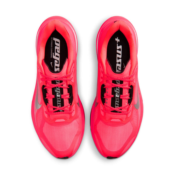 A bright pink Nike running shoe with a black and gray Swoosh logo, shown on a white background.