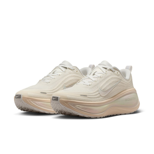 Pair of beige running shoes on a white background