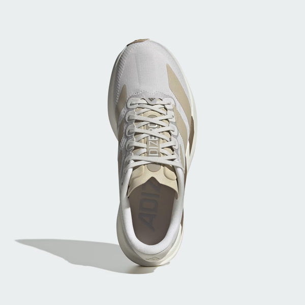 A single Adidas sneaker shown from a top-down view against a light gray background. The shoe features a white and beige mesh upper with beige overlays, white laces, and a thick white midsole.