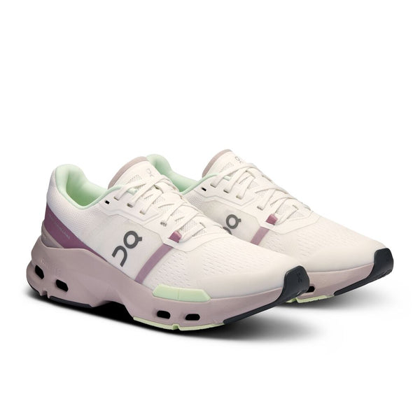 A pair of On gym adn training shoes with an off-white upper and grey midsole.