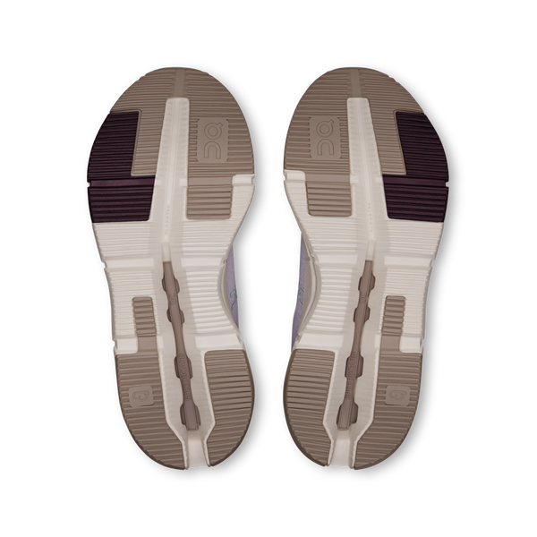 Outsole view of a pair of On shoes with a white sole and brown soles.