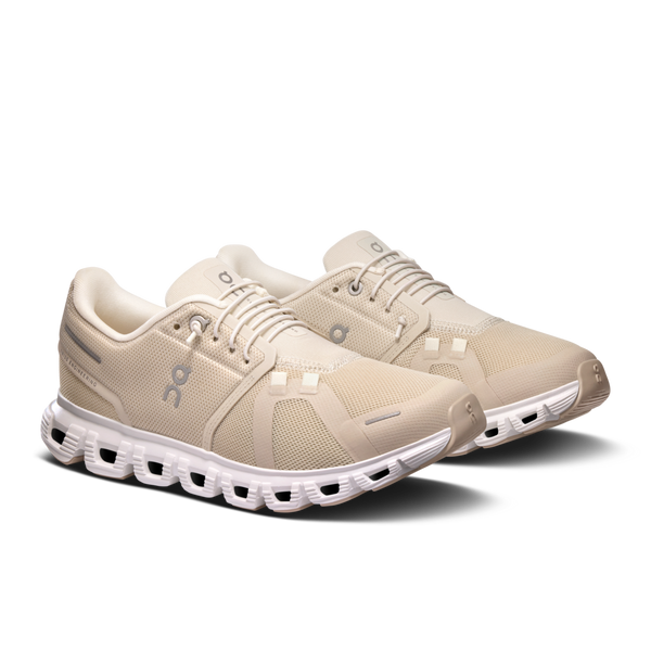 A pair of Women's On Cloud 6 shoes in a beige colorway and a white midsole.