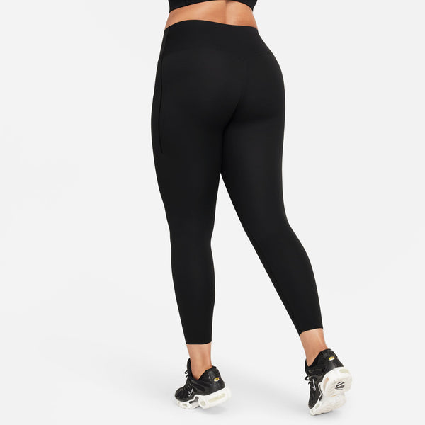Person wearing black leggings on a white background