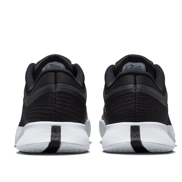 Close up of the back of these black and white women's niek tennis shoes.