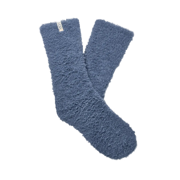 Pair of blue fuzzy socks on a light gray background