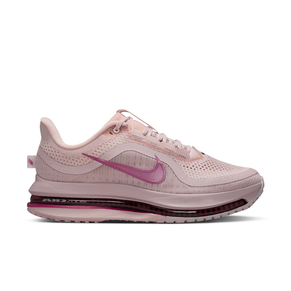 Women's pink Nike running shoe on a white background.