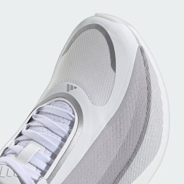 Close-up of a white and light gray athletic shoe showing the toe box, laces, and textured mesh and synthetic overlays.