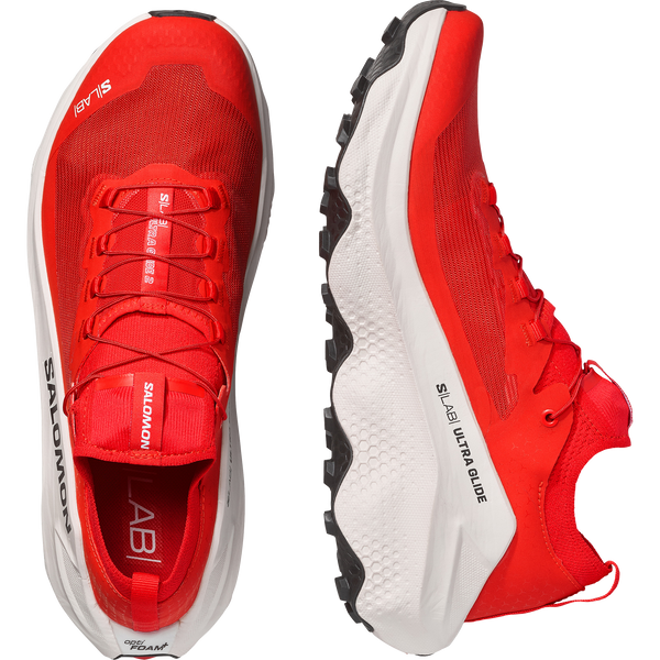 White, red, and black trail running shoe on a white background