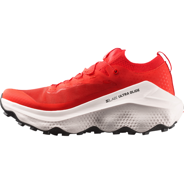 White, red, and black trail running shoe on a white background