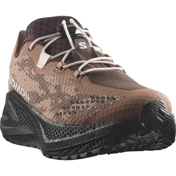 Brown and black gravel running shoe on a white background