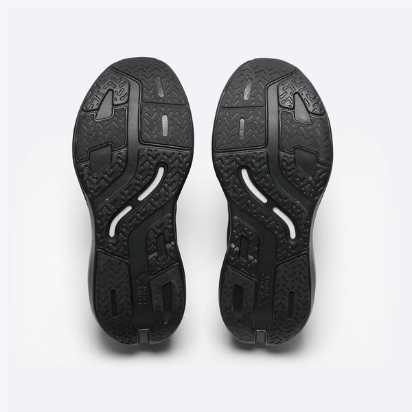A black Mount to Coast running shoe with a thick black and silver platform sole.